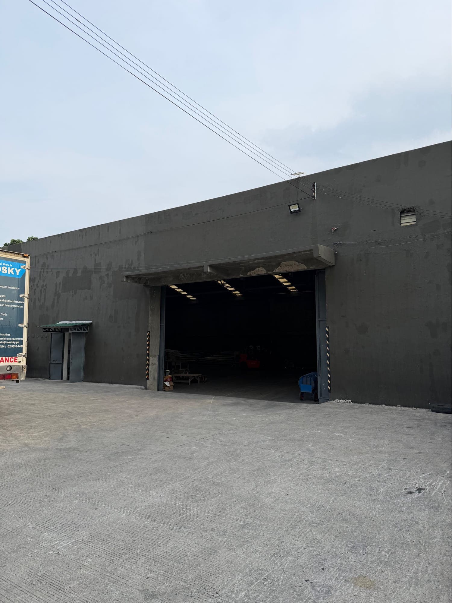 Warehouse for lease in Mandaue City with its main door open, showing the clear-span interior